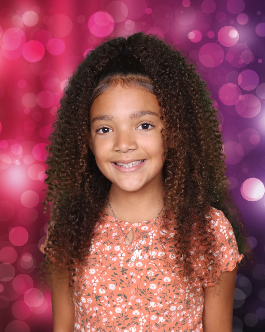 School portrait — girl with bokeh background